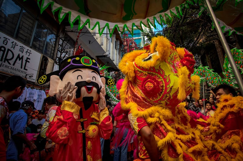 MANILA, PHILIPPINES - FEBRUARY 10: Lion and dragon dancers perform during Lunar New Year celebrations at Binondo district, considered the world's oldest Chinatown, on February 10, 2024 in Manila, Philippines. Lunar New Year, also known as Chinese New Year, is celebrated around the world, and the year of the Wood Dragon in 2024 is associated with growth, progress, and abundance, as wood represents vitality and creativity, while the dragon symbolizes success, intelligence, and honor.  (Photo by Ezra Acayan/Getty Images)