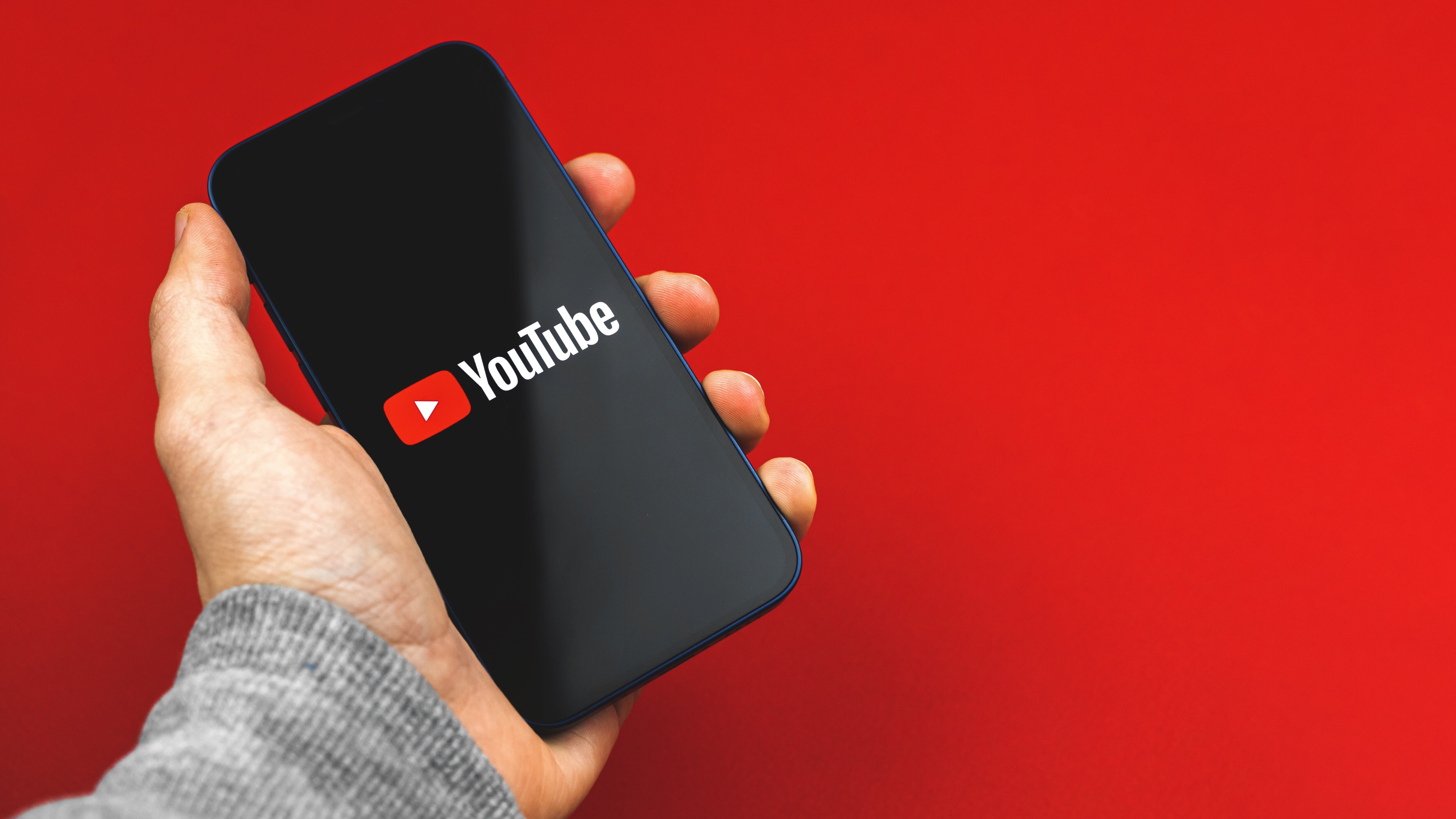 person using mobile phone with Youtube app, banner and copy space photo