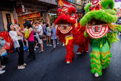 BANGKOK, THAILAND - FEBRUARY 09: A lion dance troupe performs on Yaowarat Road in Chinatown on Lunar New Years Eve on February 09, 2024 in Bangkok, Thailand. The Chinese diaspora of Southeast Asia celebrates a lively Lunar New Year in Bangkok's Chinatown. It is traditionally a time for people to meet their relatives and take part in celebrations with families. In Thailand, which has a sizeable population of Chinese lineage, people gather with family and celebrate with feasts and visits to temples. The Tourism Authority of Thailand is expecting a steep increase in tourism during the Lunar New Year now that visa free travel is permmited for Chinese citizens to Thailand. (Photo by Lauren DeCicca/Getty Images)