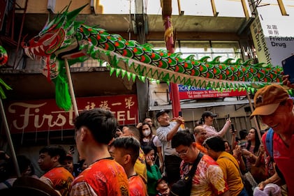 MANILA, PHILIPPINES - FEBRUARY 10: Filipinos watch dragon dancers perform during Lunar New Year celebrations at Binondo district, considered the world's oldest Chinatown, on February 10, 2024 in Manila, Philippines. Lunar New Year, also known as Chinese New Year, is celebrated around the world, and the year of the Wood Dragon in 2024 is associated with growth, progress, and abundance, as wood represents vitality and creativity, while the dragon symbolizes success, intelligence, and honor.  (Photo by Ezra Acayan/Getty Images)