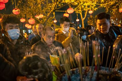 HANOI, VIETNAM - FEBRUARY 10: People pray at Tay Ho Temple to mark the start of the Lunar New Year on February 10, 2024 in Hanoi, Vietnam. Lunar New Year, also known as Chinese New Year. The day is celebrated around the world, and The Year of the Wood Dragon in 2024 is associated with growth, progress, and abundance, as wood represents vitality and creativity, while the dragon symbolizes success, intelligence, and honor. (Photo by Linh Pham/Getty Images)